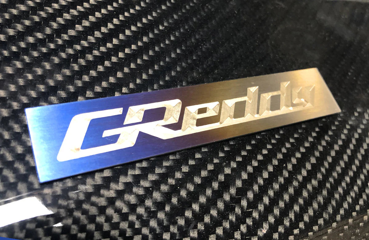 GReddy Performance Parts Optional Titanium GReddy Emblem - (105x20mm)