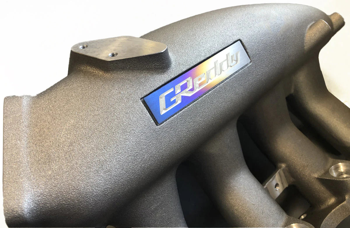 GReddy Performance Parts Optional Titanium GReddy Emblem - (105x20mm)