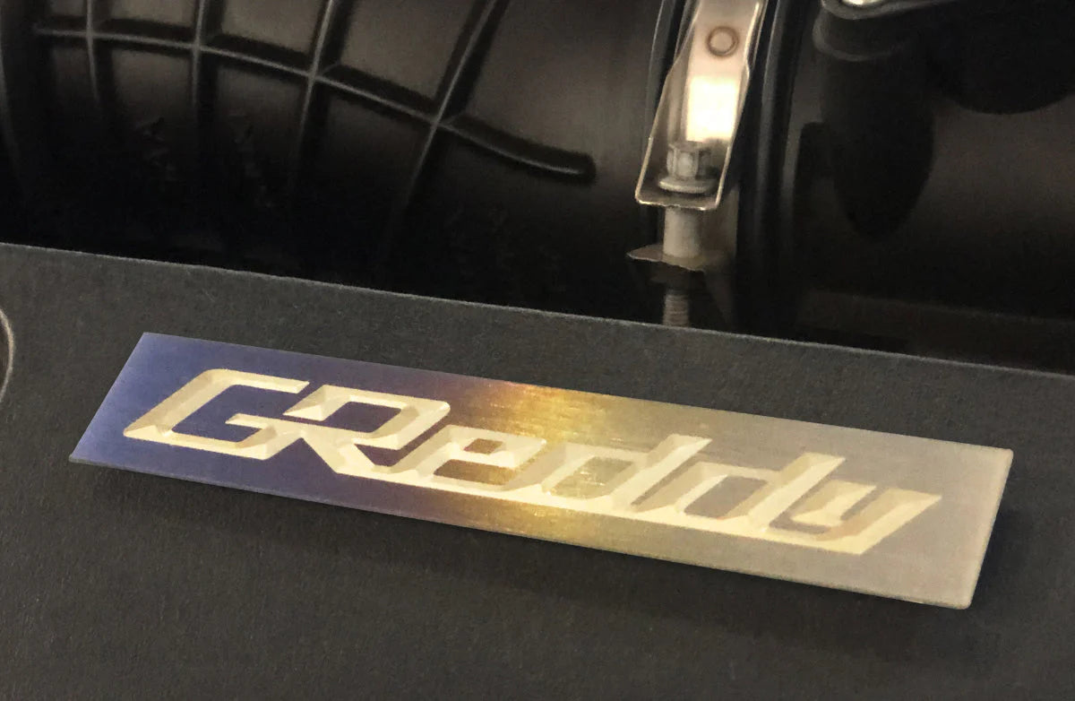 GReddy Performance Parts Optional Titanium GReddy Emblem - (105x20mm)