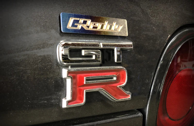 GReddy Performance Parts Titanium GReddy Emblem - (70x15mm)