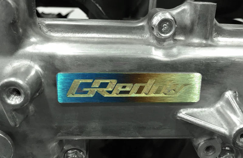 GReddy Performance Parts Titanium GReddy Emblem - (70x15mm)