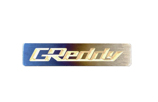 GReddy Performance Parts Titanium GReddy Emblem - (70x15mm)